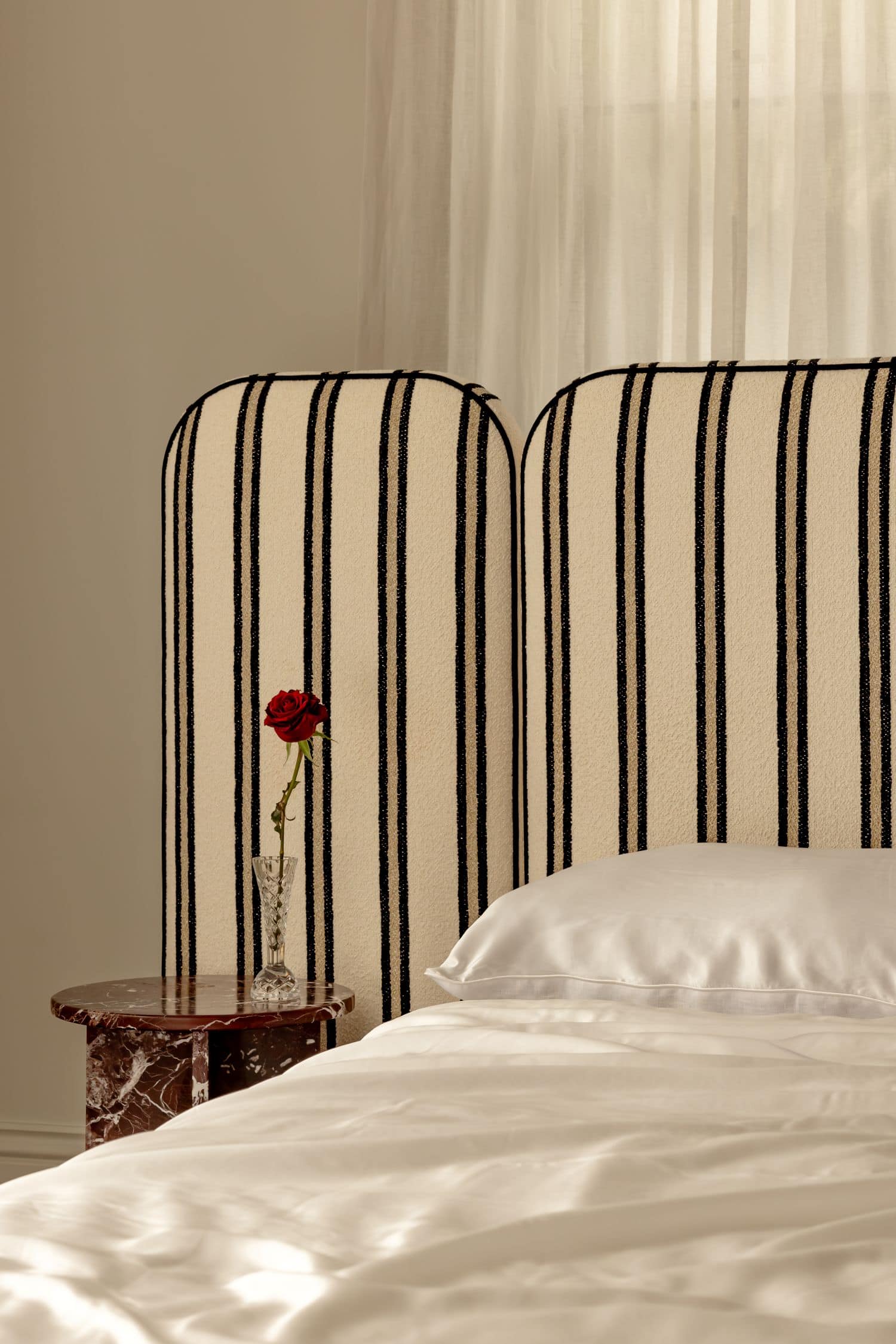 Bone Made x BedsAhead Willow Bed styled with white sheets and a single red rose