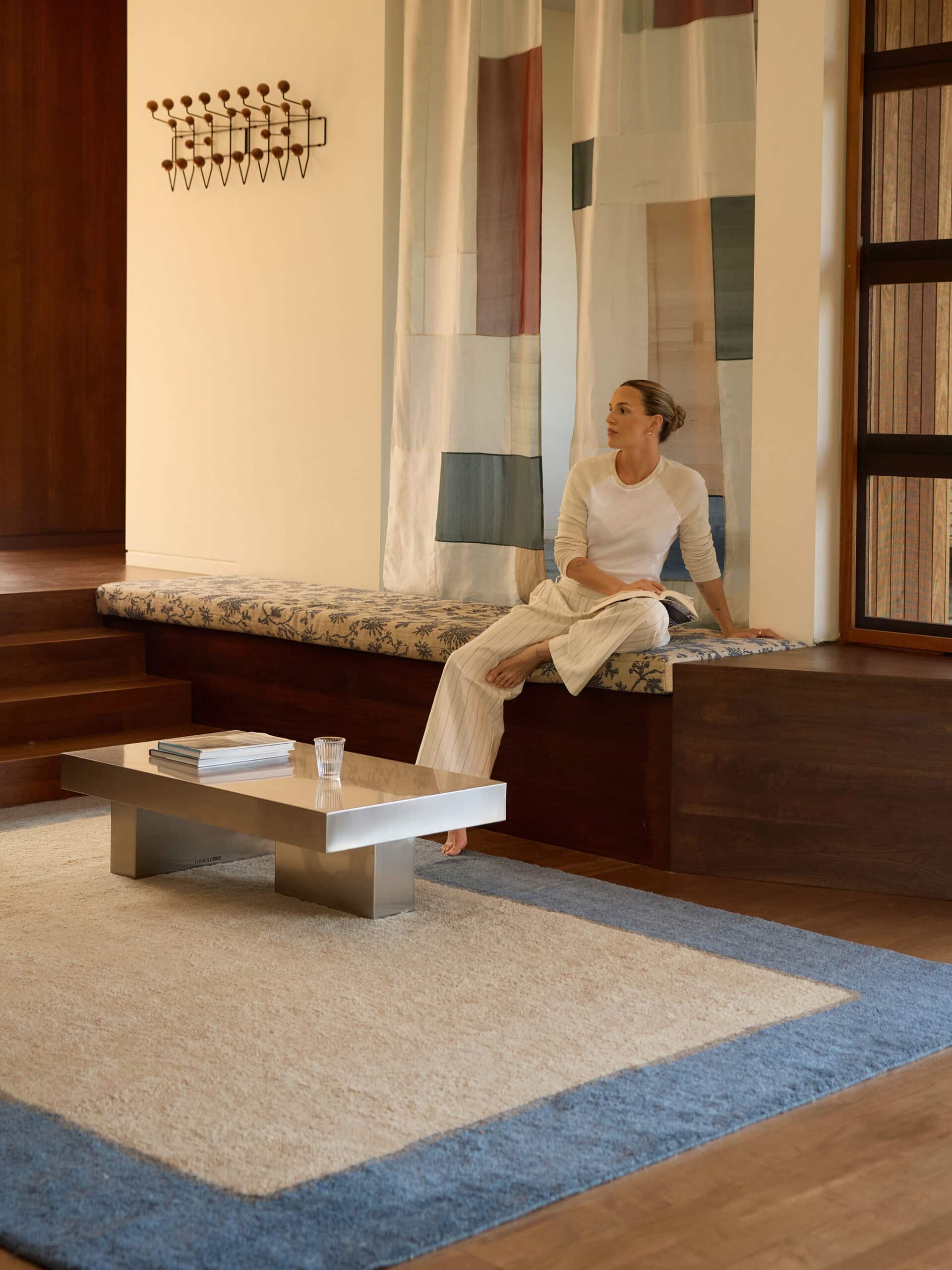 Field rug in Sand by Olive Cooke x Double Studio beneath a steel coffee table in a living room