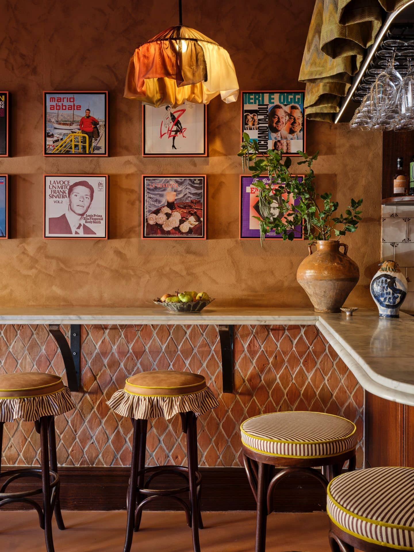 A cosy corner in Vineria Luisa in Enmore featuring bar seating and vinyls on the wall.