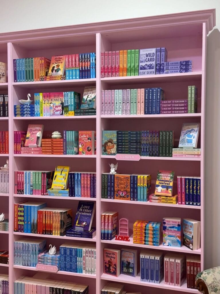 A pink bookshelf stacked with books at Romancing the Novel in Brisbane