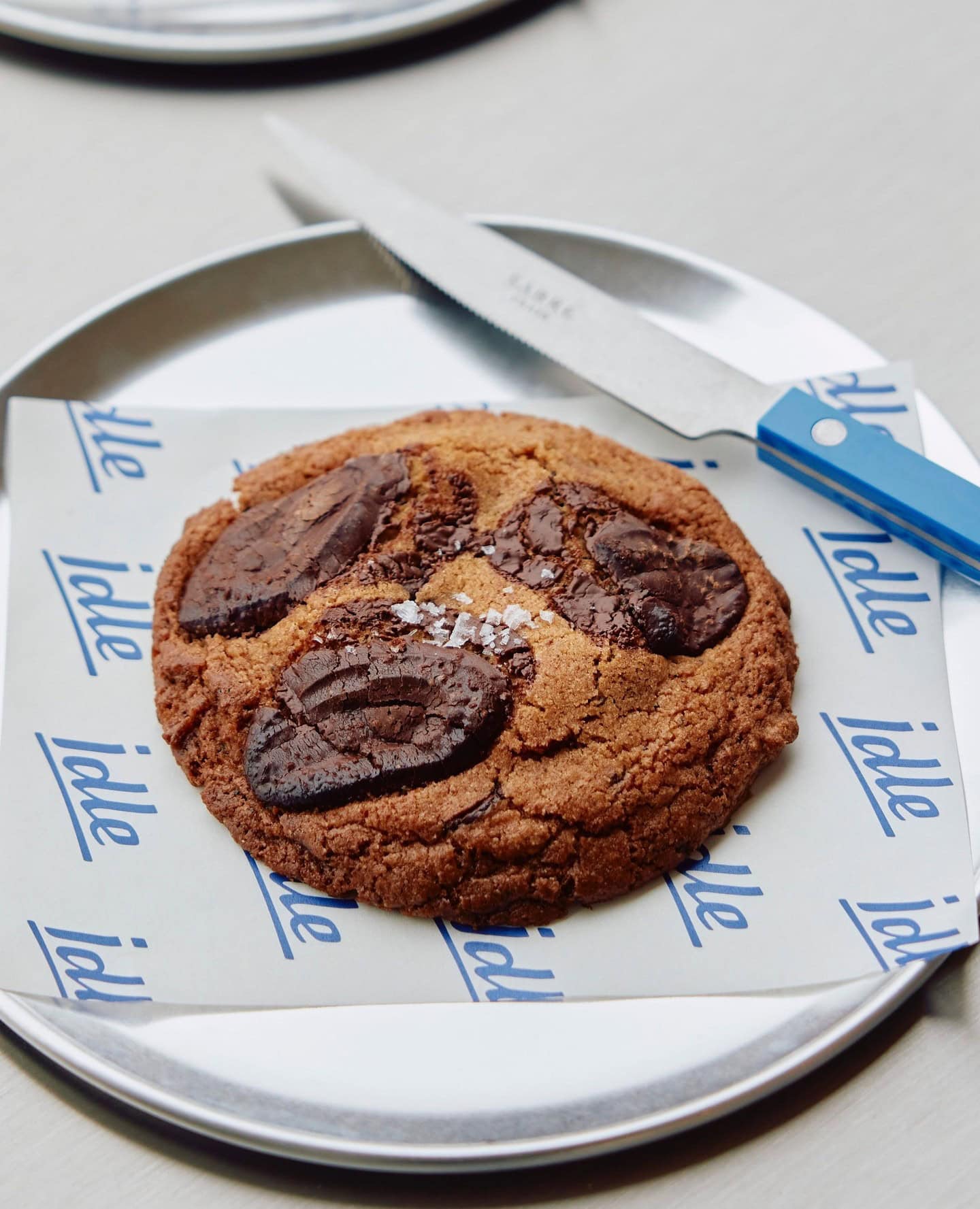 A chocolate chip cookie on a plate at Idle Bakery in Brisbane.