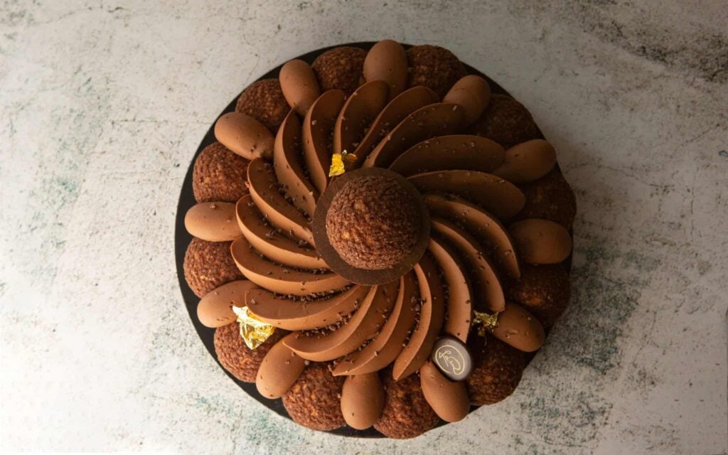 Chocolate Saint-Honoré cake with piped chocolate chantilly, choux puffs and gold leaf, from La Renaissance French patisserie, The Rocks and Waterloo Sydney