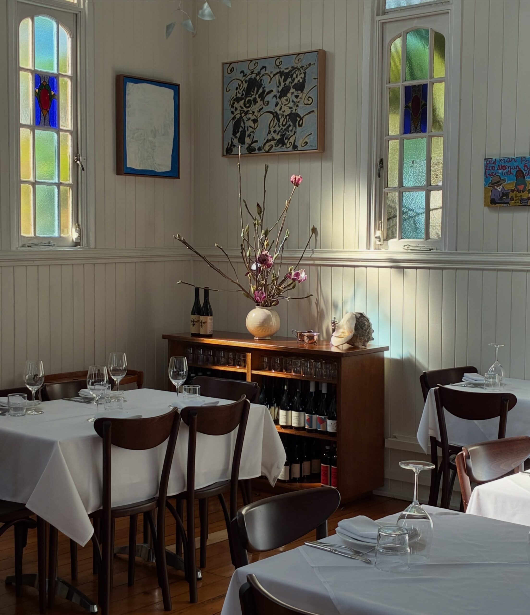 The sun-dappled dining room at August in West End
