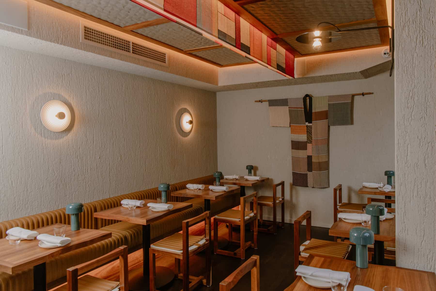 Second-floor dining room with timber tables, banquette seating and a hanging textile artwork at Itō, Surry Hills Sydney