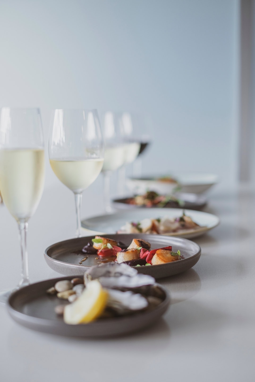 Plates of food and glasses of champagne at Bills Fishhouse & Bar in Port Macquarie.