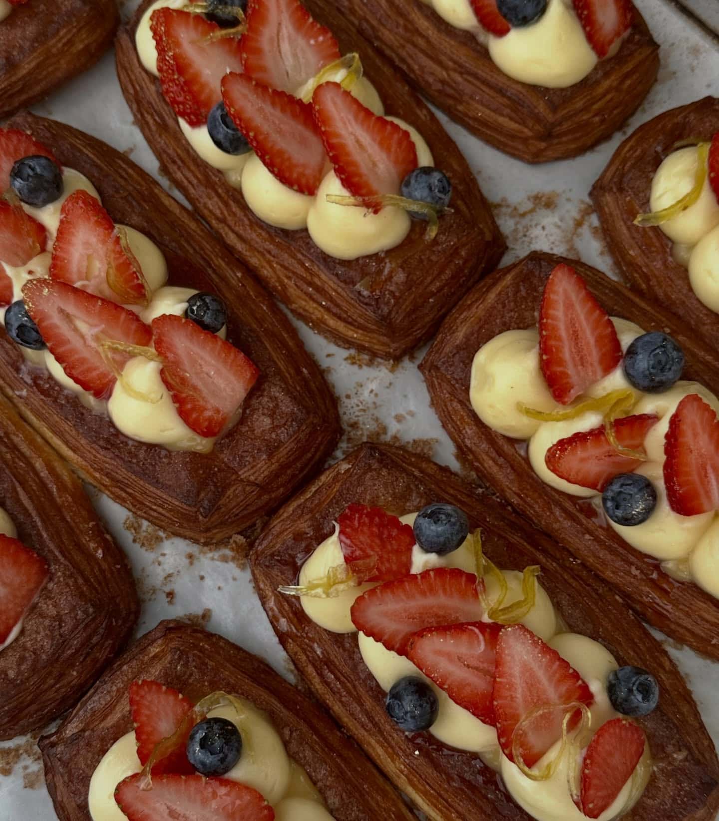 An aerial view of a tray of fruit and custard Danishes from Flour and Chocolate in Brisbane.