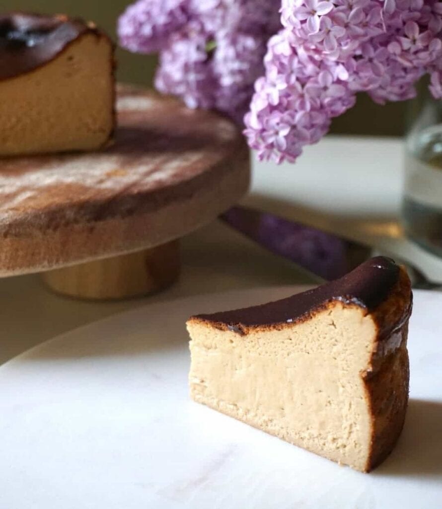 Slice of gluten-free Japanese Basque cheesecake with a caramelised top on a marble board at 15cenchi dessert bar, Haymarket Sydney