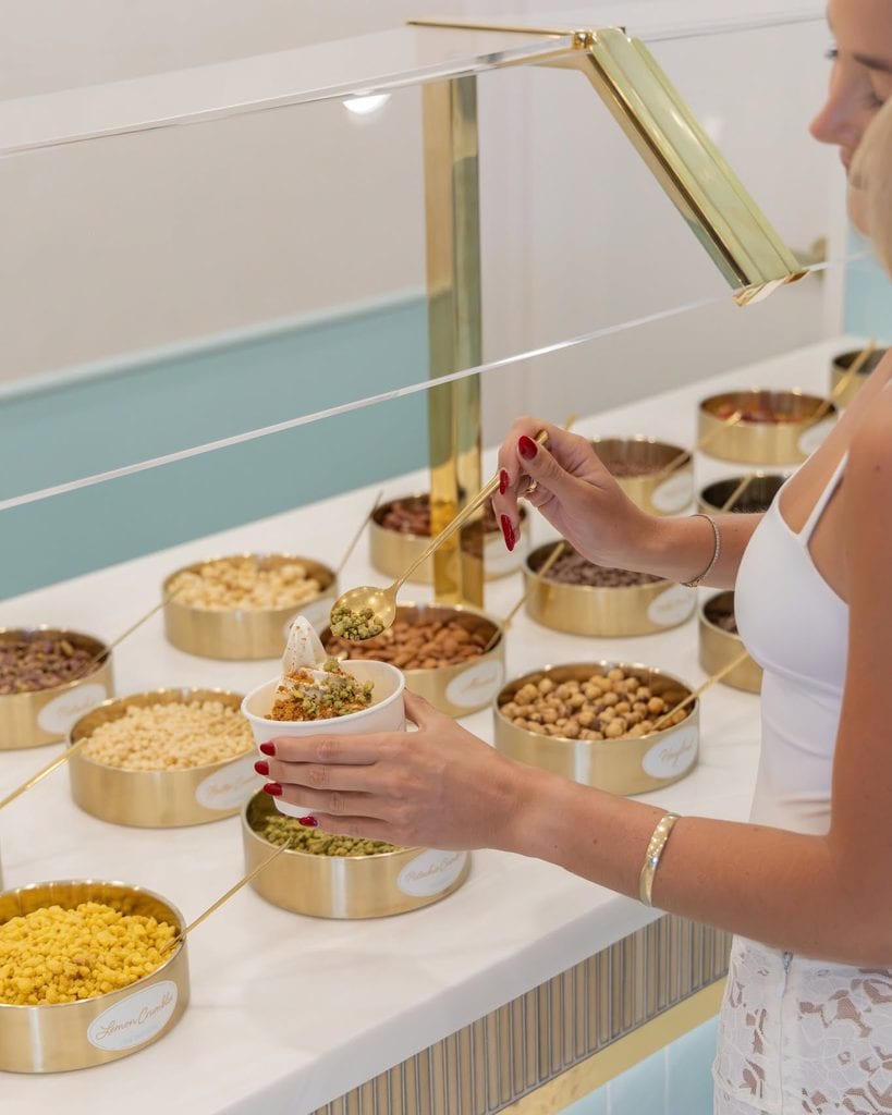 A woman putting toppings on her gelato at Luma Gelato in Brisbane. 