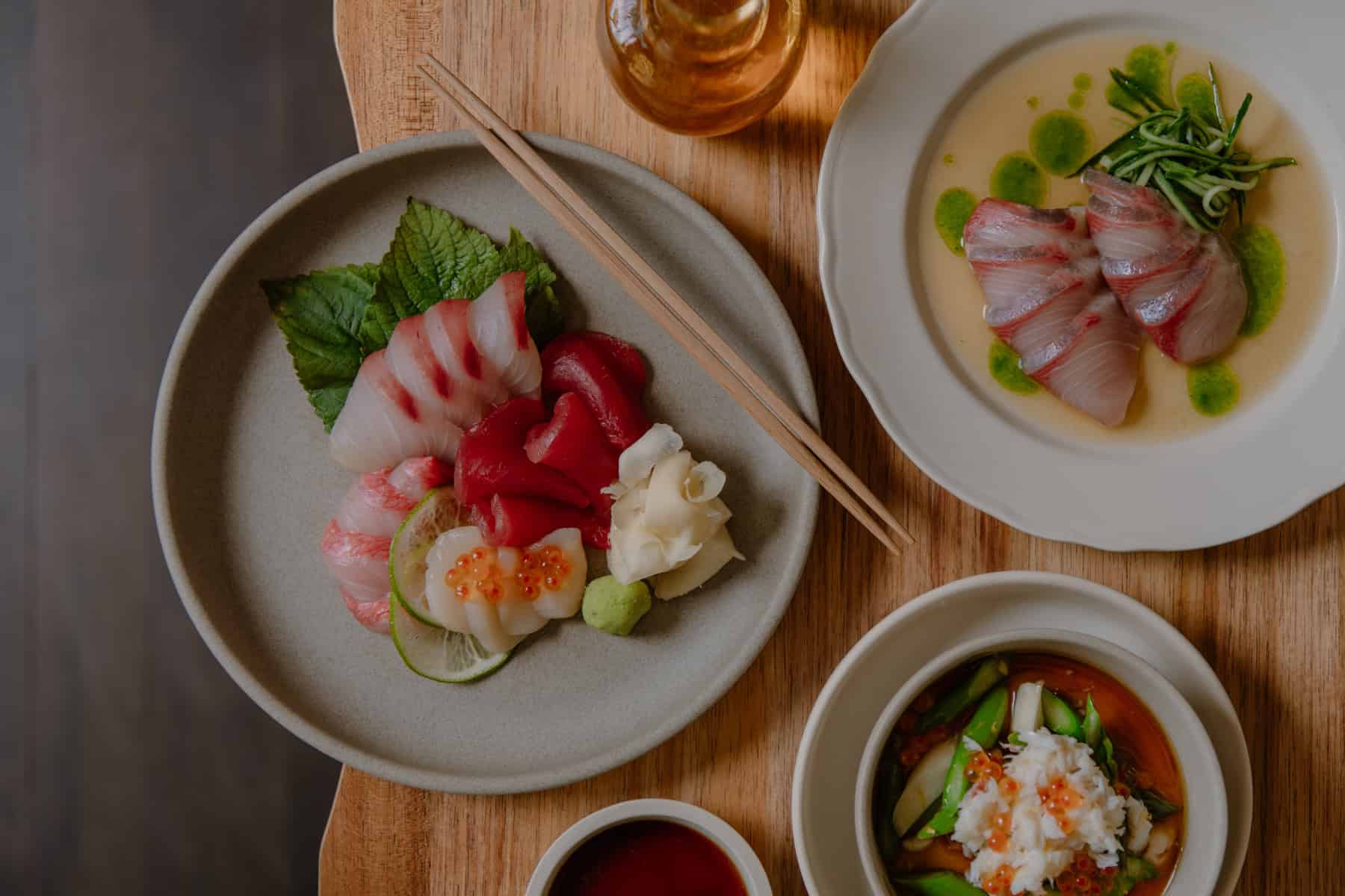 Sashimi with ginger and wasabi, hiramasa kingfish in white soy with cucumber, and spanner crab chawanmushi with asparagus and ikura at Itō, Surry Hills Sydney, awarded one Hat in the Good Food Guide 2026