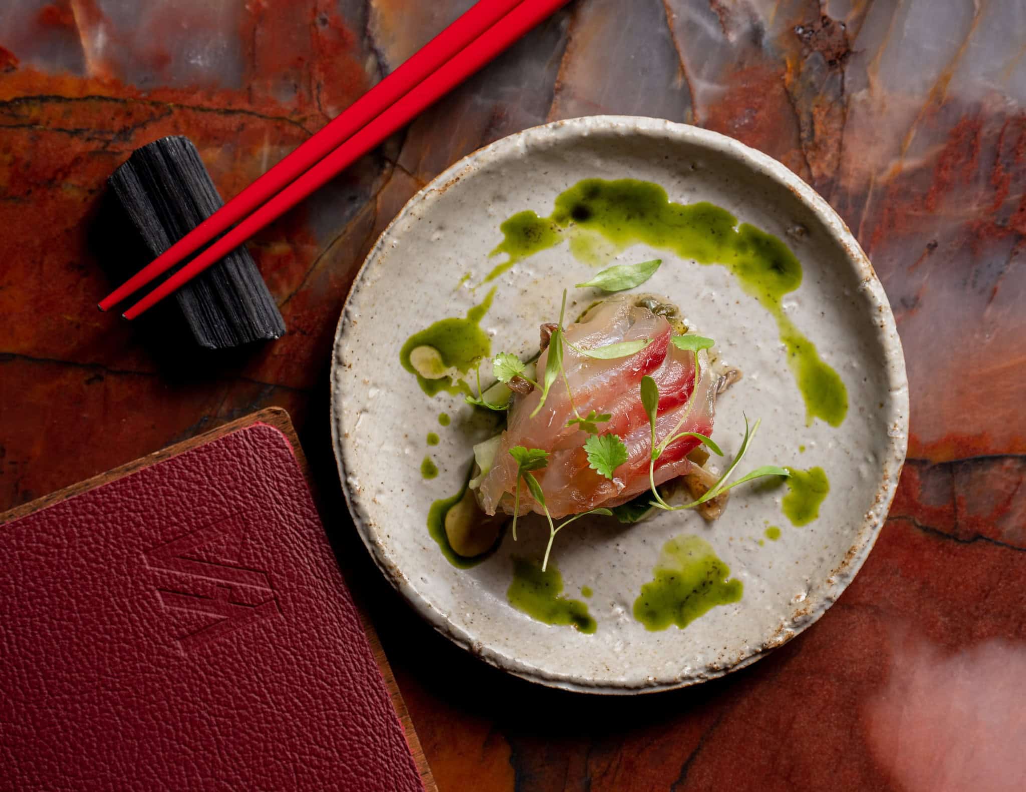 Sashimi with herb oil and microherbs at Restaurant Ka, Darlinghurst Sydney, awarded one Hat in the Good Food Guide 2026