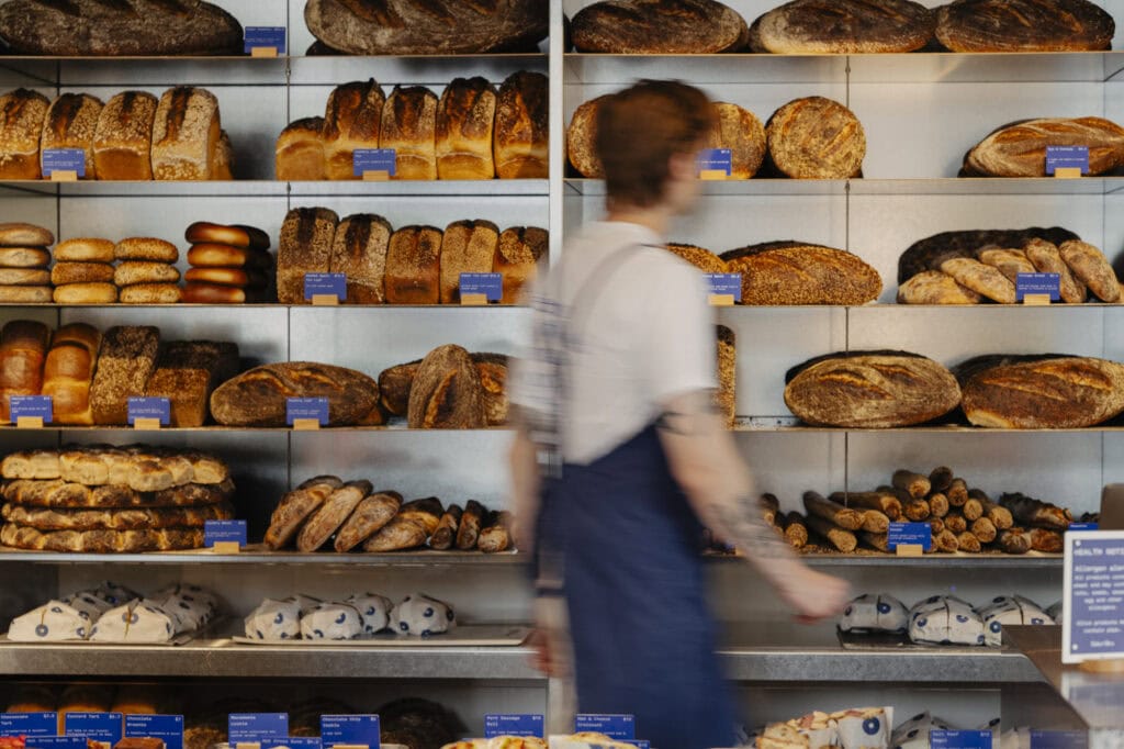 Shelves of sourdough loaves, bagels and baguettes at Baker Bleu, the bakery giving away free sourdough in Double Bay Sydney for its 10th birthday