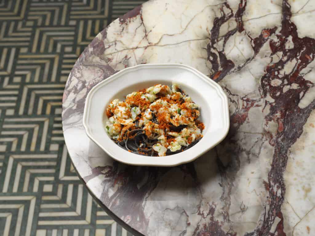 Squid ink spaghetti topped with seafood and toasted breadcrumbs at Cibaria Manly, Manly Sydney, awarded one Hat in the Good Food Guide 2026