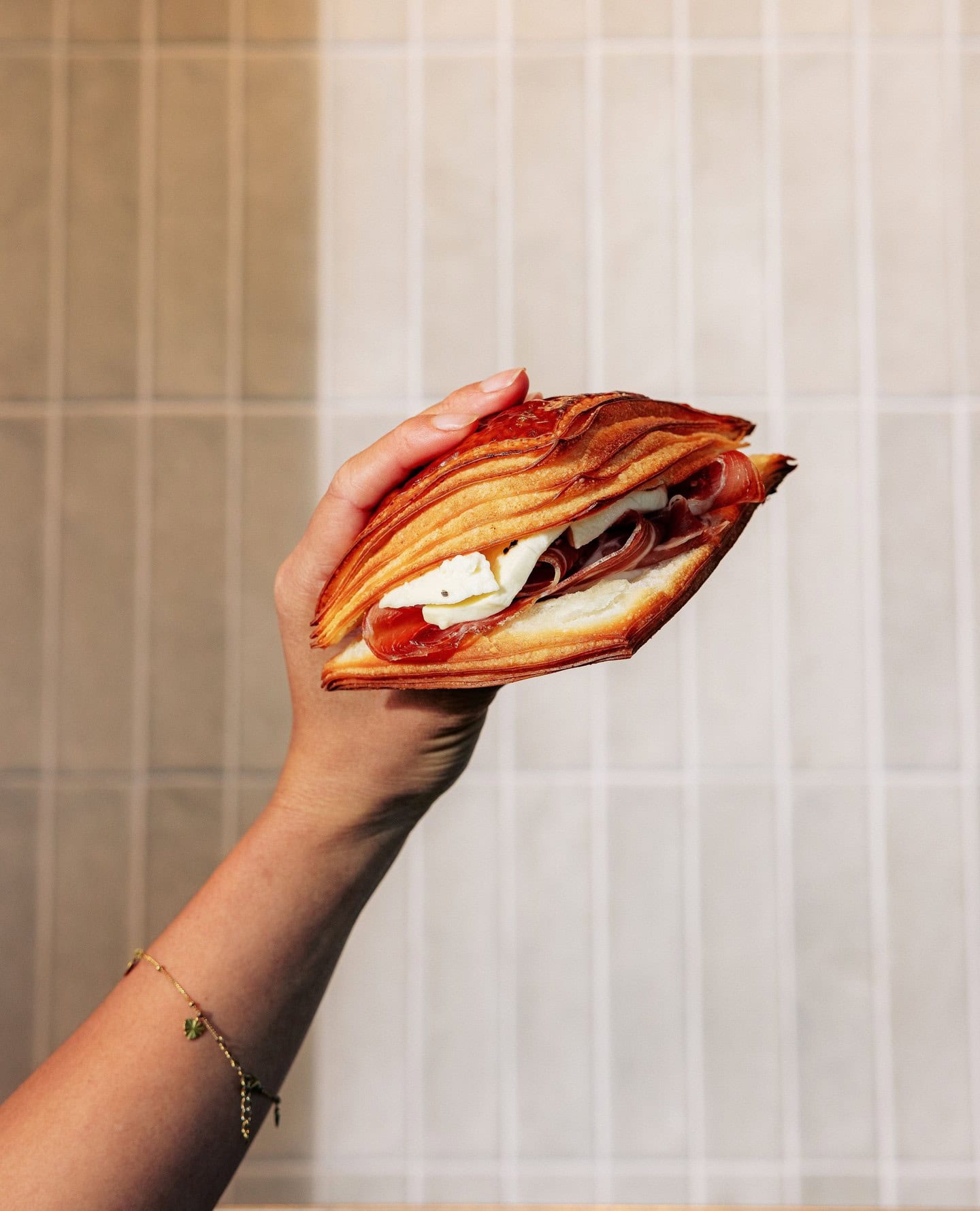 Someone holding up a toastie from Sprout Artisan Bakery in Brisbane.