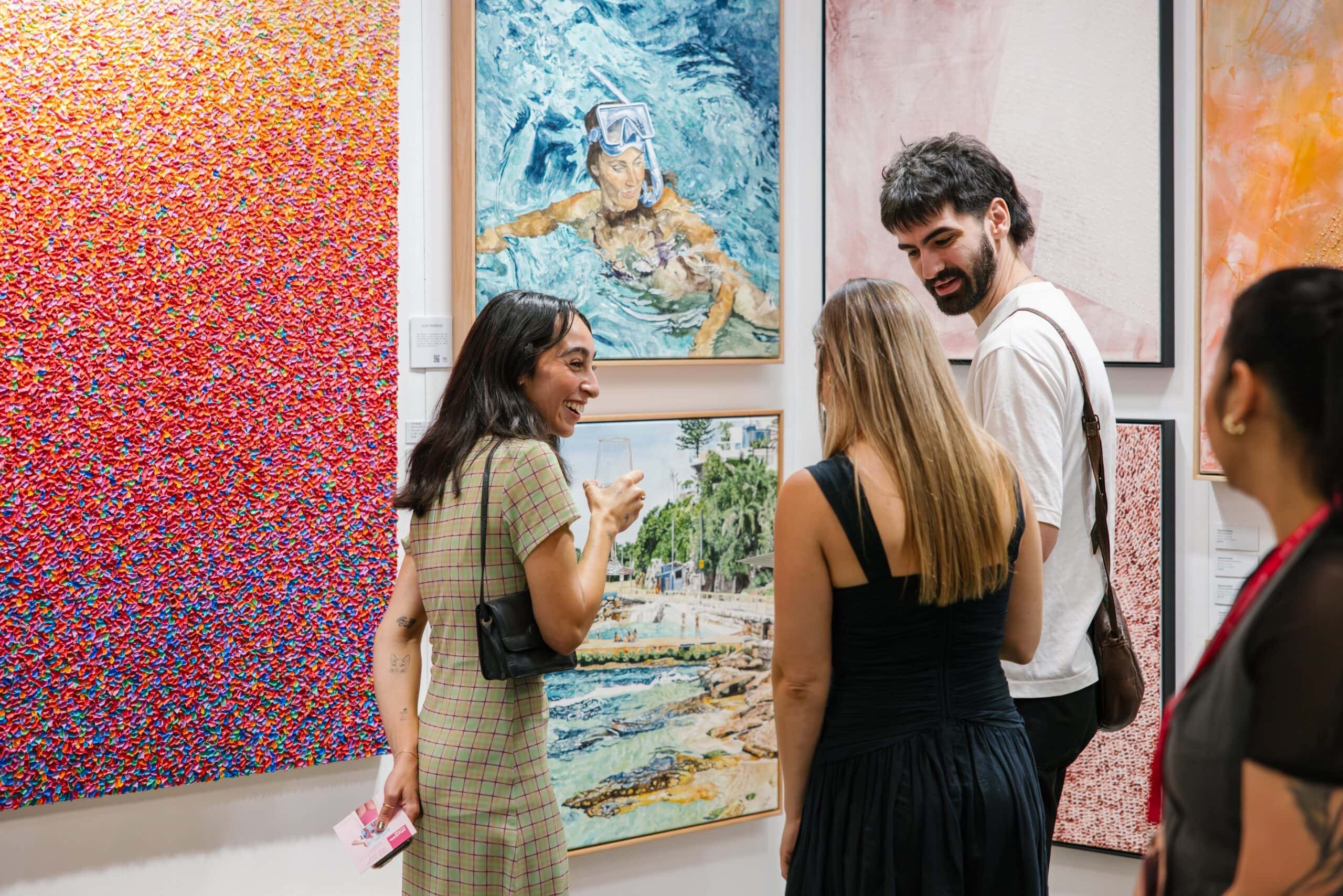 isitors admiring colourful framed artworks at Affordable Art Fair Sydney