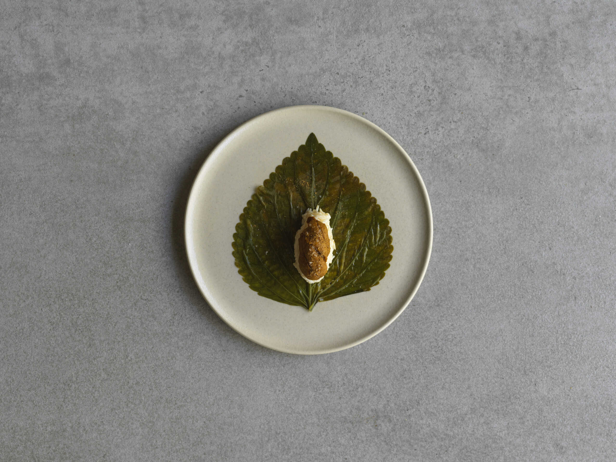 Waraq simsim with aged rice, sea urchin and cumin on a perilla leaf at Aalia, Martin Place Sydney CBD